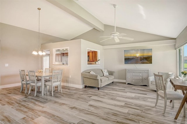 dining space with beamed ceiling, ceiling fan with notable chandelier, light hardwood / wood-style floors, and high vaulted ceiling