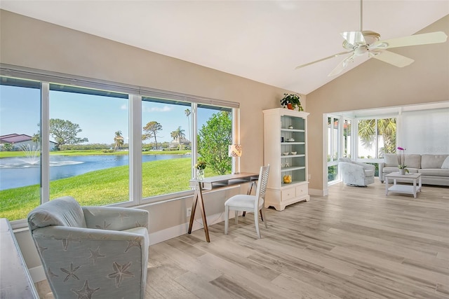 sunroom featuring plenty of natural light, ceiling fan, a water view, and vaulted ceiling