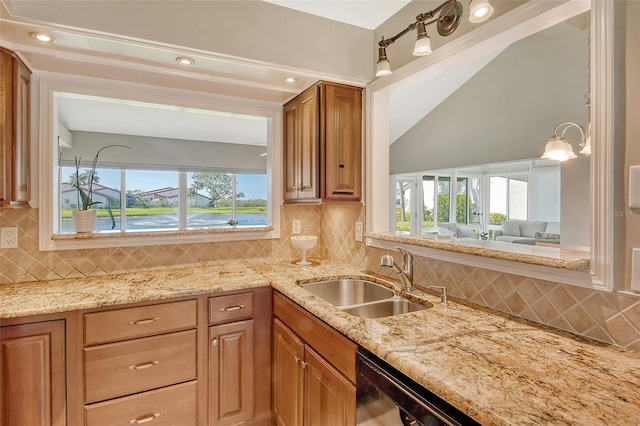 kitchen with decorative backsplash, a water view, and a wealth of natural light