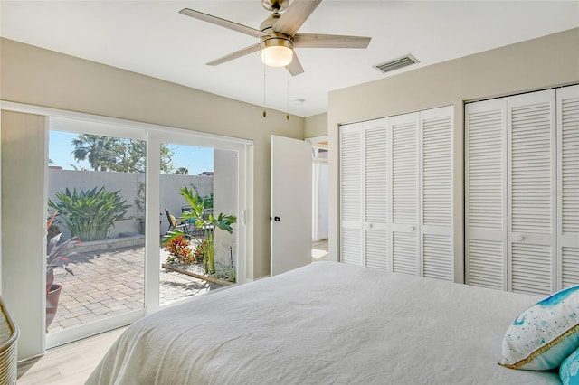 bedroom featuring multiple closets, access to outside, ceiling fan, and light hardwood / wood-style floors