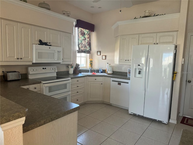 kitchen with white appliances, sink, light tile patterned floors, white cabinetry, and kitchen peninsula