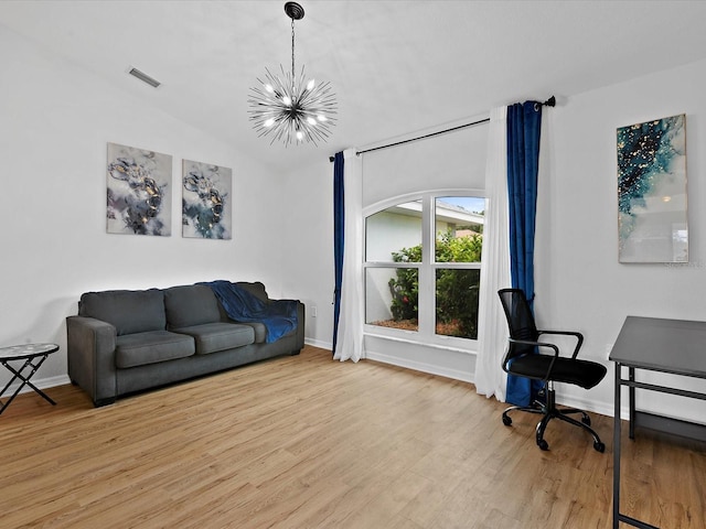 office with a notable chandelier, lofted ceiling, and light hardwood / wood-style flooring