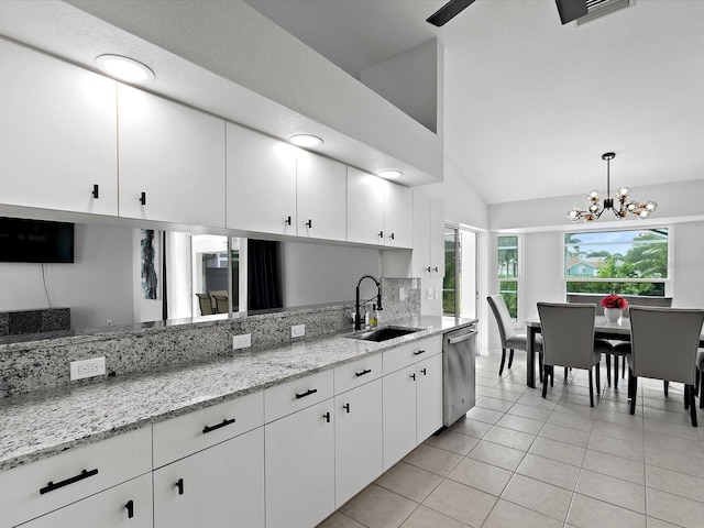 kitchen featuring dishwasher, an inviting chandelier, white cabinets, sink, and decorative light fixtures