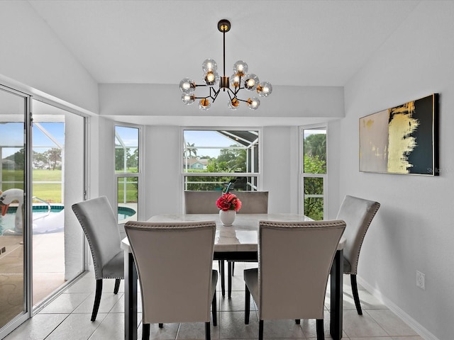 dining space with light tile patterned floors and a notable chandelier