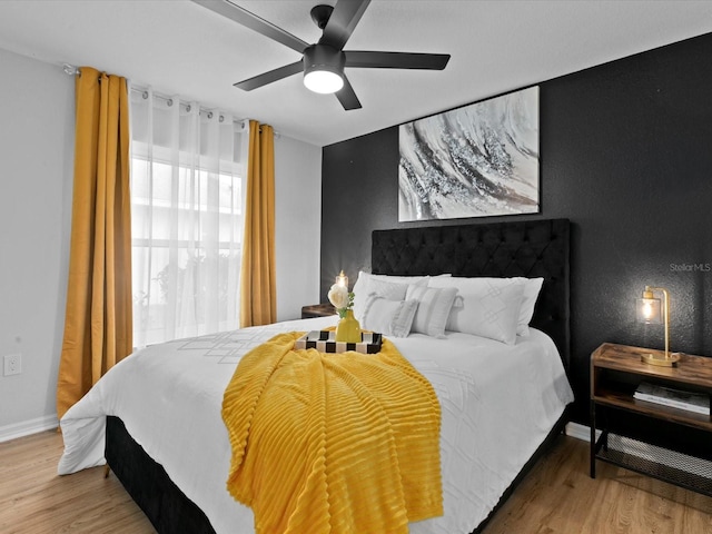 bedroom with hardwood / wood-style floors and ceiling fan