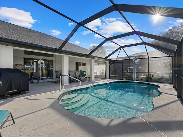 view of swimming pool featuring a patio area, a grill, and glass enclosure