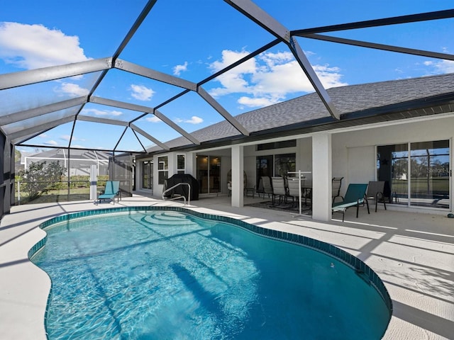 view of swimming pool featuring a lanai and a patio area