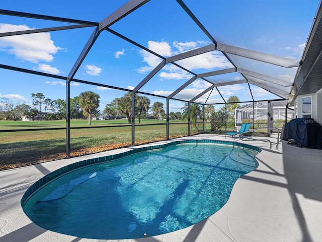 view of pool featuring a patio, area for grilling, a lanai, and a lawn