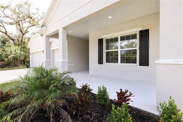 view of exterior entry featuring a garage