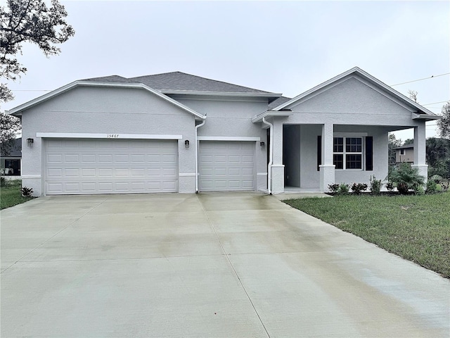 view of front of house featuring a garage, a porch, and a front lawn