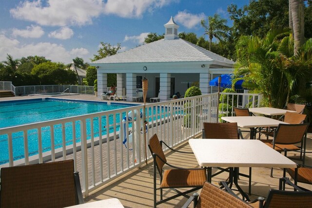 815 Montrose Dr Unit 103, Venice, FL 34293 - community pool with outdoor dining area, fence, a patio, and a gazebo