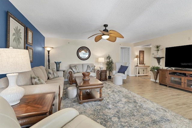 living room with ceiling fan and hardwood / wood-style flooring