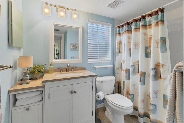 bathroom featuring tile patterned flooring, a textured ceiling, toilet, vanity, and a shower with shower curtain