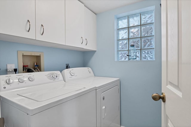 washroom featuring cabinets and separate washer and dryer