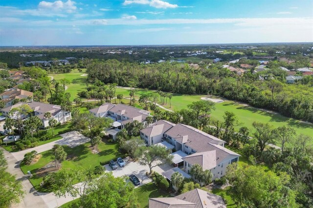 815 Montrose Dr Unit 103, Venice, FL 34293 - aerial view of residential area featuring a local golf course and a tree filled landscape