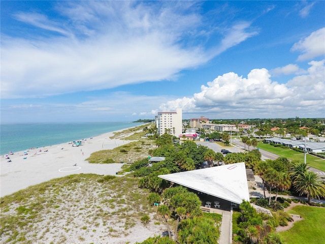 drone / aerial view featuring a beach view and a water view