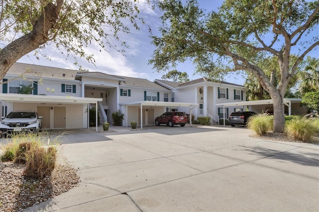 815 Montrose Dr Unit 103, Venice, FL 34293 - view of front of home with stairs, stucco siding, and covered parking