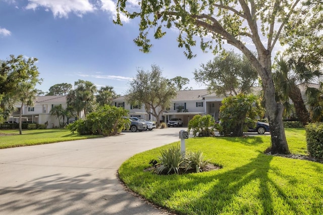 815 Montrose Dr Unit 103, Venice, FL 34293 - obstructed view of property featuring a front yard, a residential view, and driveway
