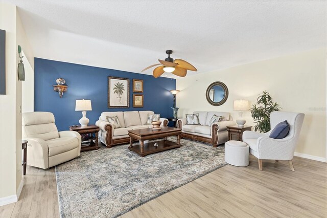 815 Montrose Dr Unit 103, Venice, FL 34293 - living room featuring a ceiling fan, wood finished floors, and baseboards