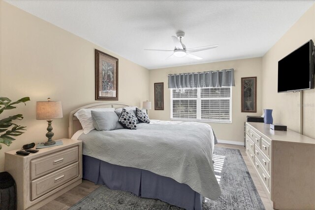 815 Montrose Dr Unit 103, Venice, FL 34293 - bedroom with light wood-style flooring, a ceiling fan, and baseboards