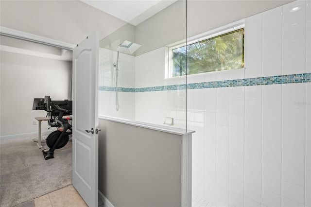 bathroom with tile patterned flooring and tiled shower