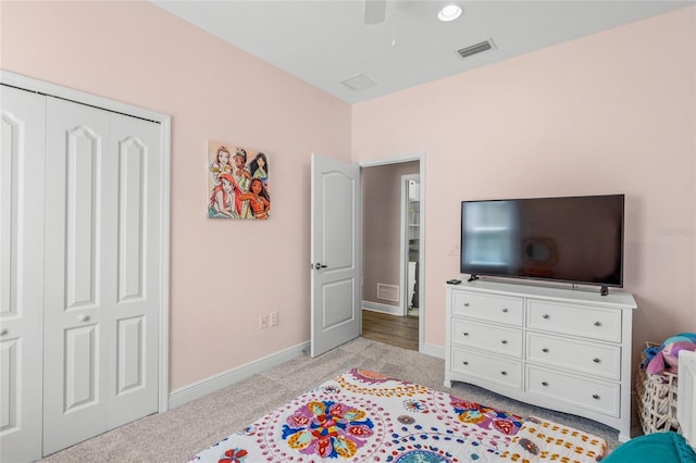 bedroom with ceiling fan, a closet, and light colored carpet