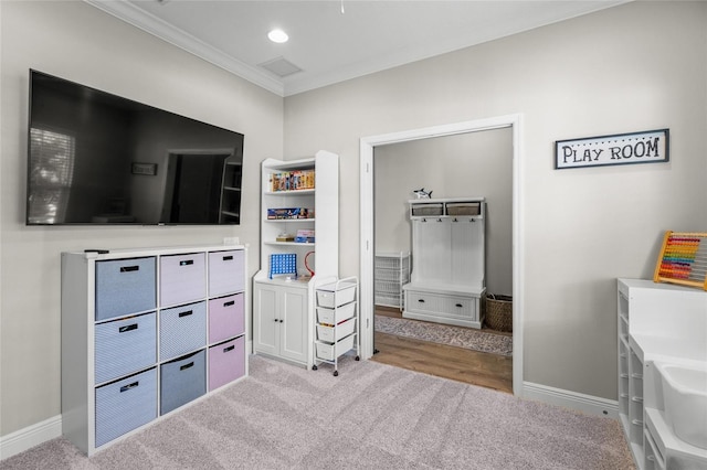 bedroom featuring light colored carpet and ornamental molding