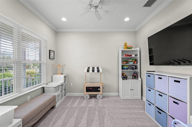 sitting room featuring ceiling fan, light colored carpet, and ornamental molding