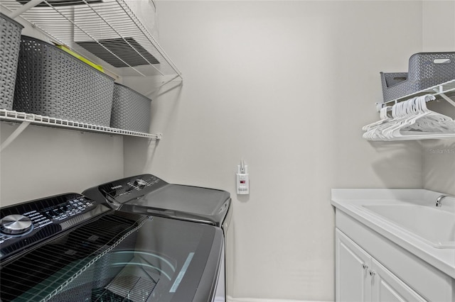 laundry room with washer and dryer and sink