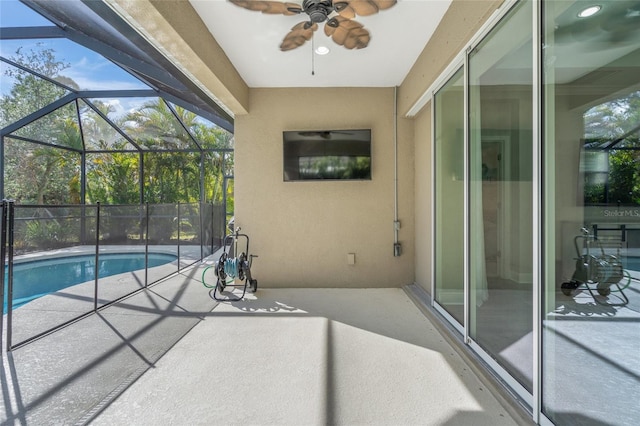 view of pool featuring a lanai, ceiling fan, and a patio area