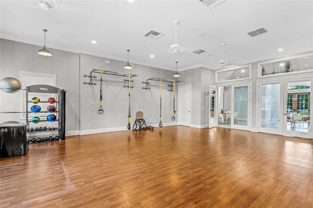 exercise room featuring ceiling fan, french doors, crown molding, and hardwood / wood-style flooring