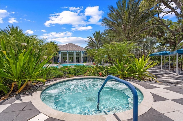 view of pool with an in ground hot tub