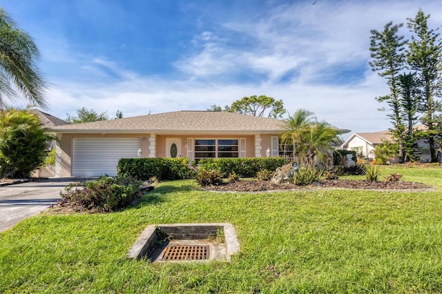 ranch-style home featuring a garage and a front yard