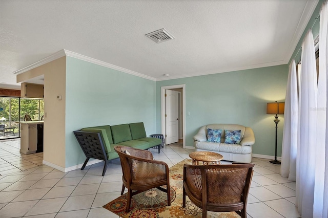 tiled living room featuring a textured ceiling and ornamental molding