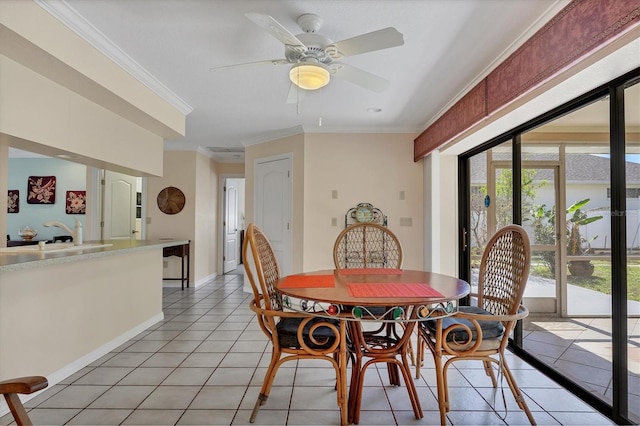 dining area featuring ceiling fan, ornamental molding, and light tile patterned floors