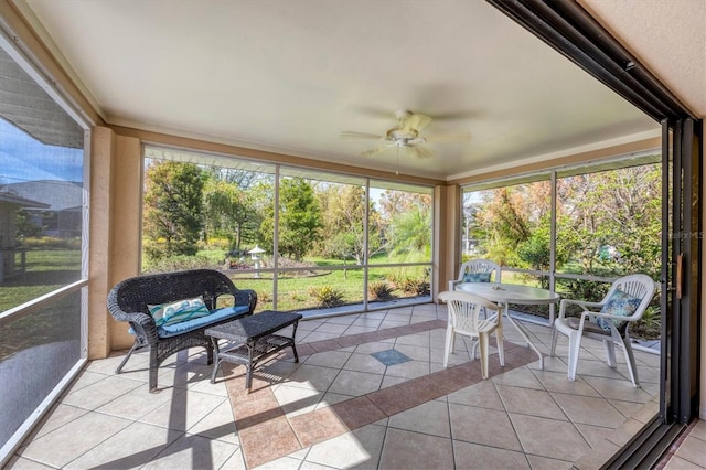 sunroom / solarium featuring ceiling fan and a healthy amount of sunlight