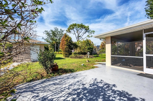 view of patio featuring a sunroom