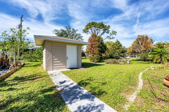 view of outbuilding with a yard