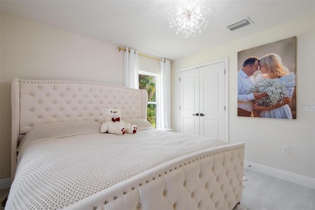 bedroom featuring a closet and a notable chandelier