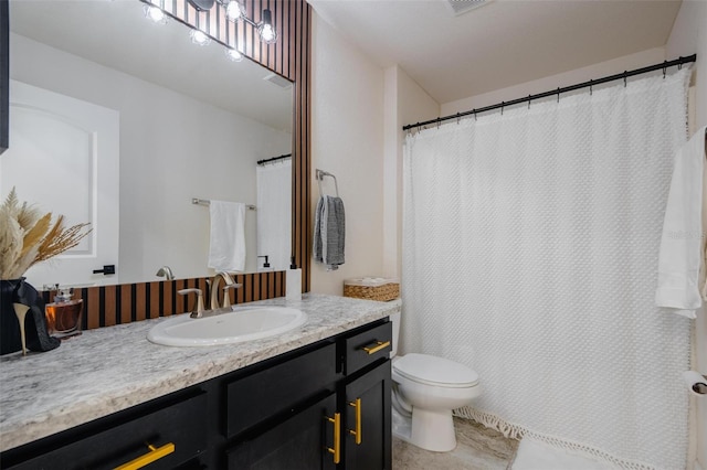 bathroom with tile patterned floors, vanity, and toilet