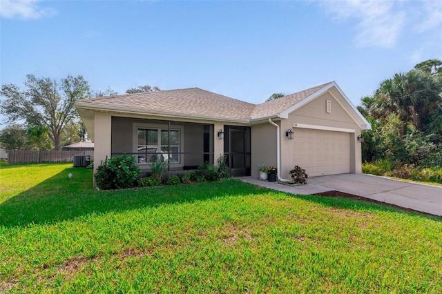 ranch-style home with cooling unit, a front yard, and a garage