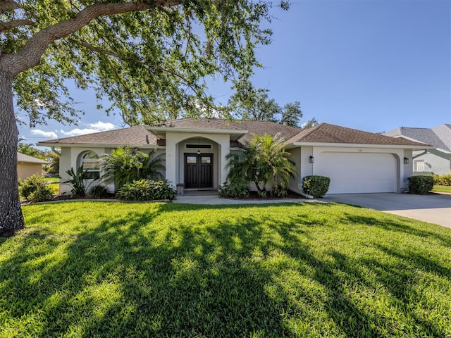 view of front facade with a garage and a front lawn