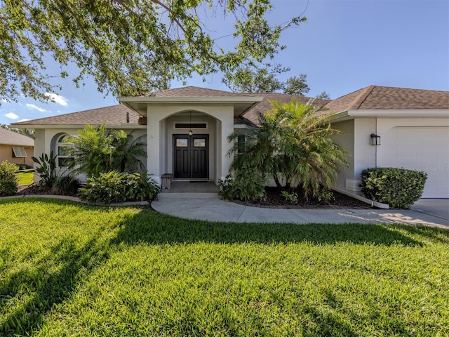 view of front facade with a front yard and a garage