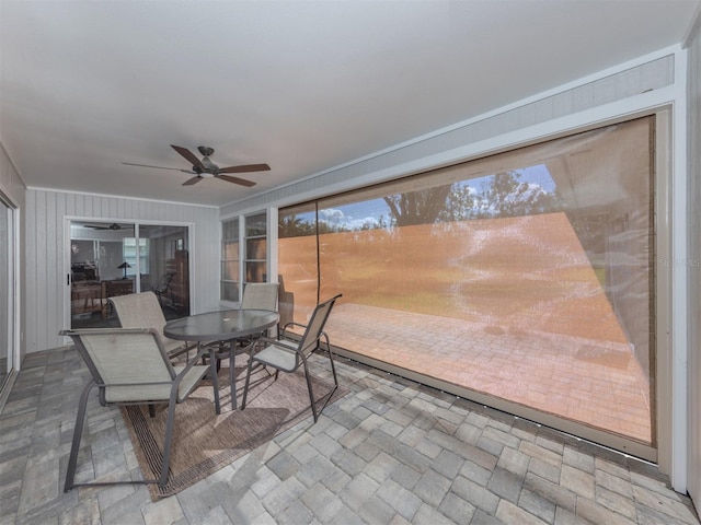 sunroom / solarium featuring ceiling fan