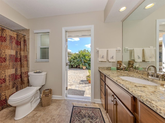 bathroom with tile patterned floors, vanity, and toilet