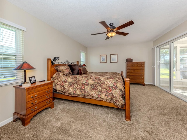 bedroom with access to exterior, carpet flooring, multiple windows, and ceiling fan