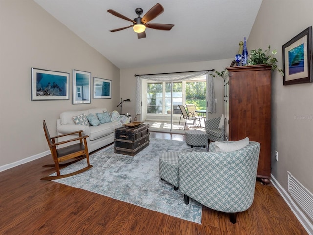 living room featuring ceiling fan, dark hardwood / wood-style flooring, and vaulted ceiling