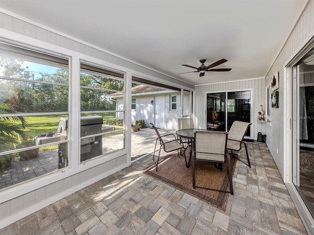 sunroom / solarium featuring ceiling fan