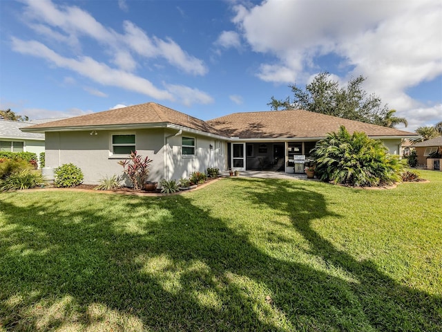 rear view of house featuring a patio area and a lawn