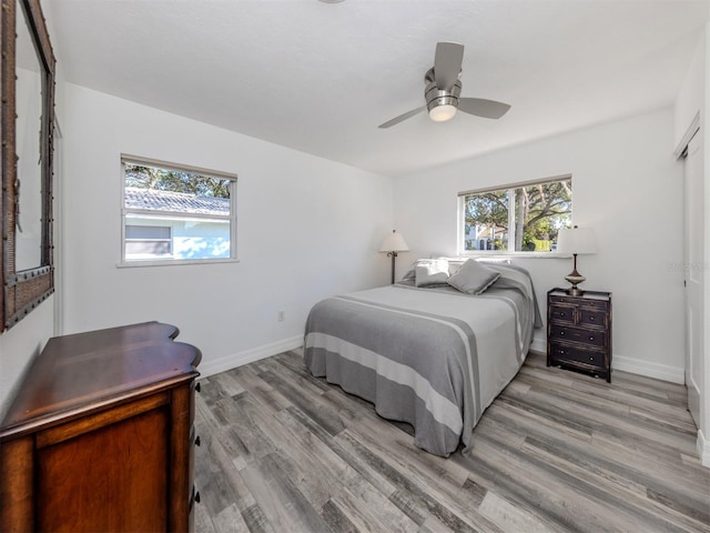 bedroom with ceiling fan and light wood-type flooring